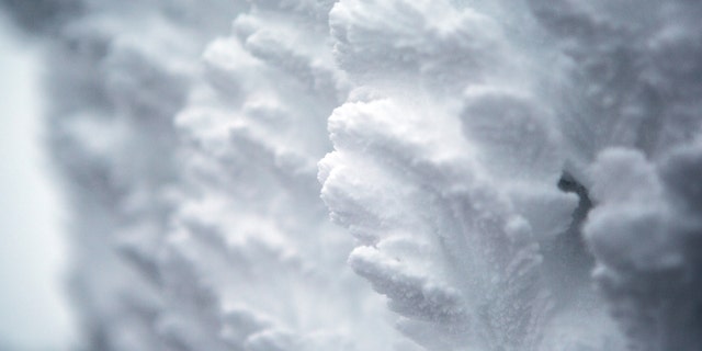 Rime ice grows on the side of the Mount Washington Observatory at the summit of Mount Washington. 