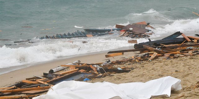 Debris and other wreckage from a migrant boat seen at a beach near Cutro, southern Italy, Sunday, Feb. 26, 2023. 