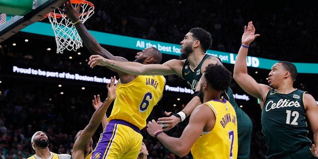 The Los Angeles Lakers' LeBron James (6) misses a shot against the Boston Celtics' Jayson Tatum, top center, late in the fourth quarter of a game Saturday, Jan. 28, 2023, in Boston.