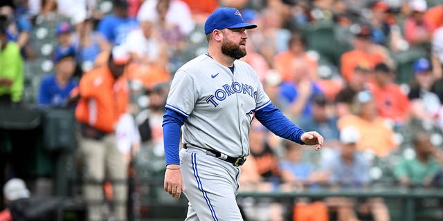 Interim manager John Schneider #14 of the Toronto Blue Jays walks across the field during the game against the Baltimore Orioles at Oriole Park at Camden Yards during game one of a double header on September 5, 2022, in Baltimore, Maryland.