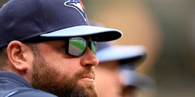 Manager John Schneider #14 of the Toronto Blue Jays watches the game in the eighth inning against the Baltimore Orioles during game one of a doubleheader at Oriole Park at Camden Yards on October 5, 2022, in Baltimore, Maryland.