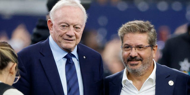 Dallas Cowboys team owner Jerry Jones and Dan Snyder, co-owner and co-CEO of the Washington Commanders, pose for a photo on the field during warmups before a NFL football game in Arlington, Texas, Sunday, Oct. 2, 2022.