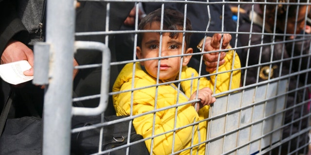 Syrians wait to cross into Syria from Turkey at the Cilvegozu border gate, near the town of Antakya, southeastern Turkey, Tuesday, Feb. 21, 2023. 