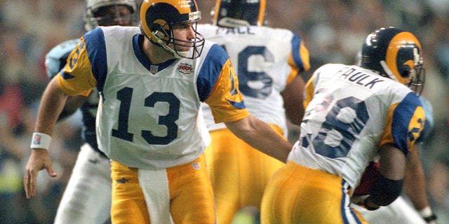 Kurt Warner of St. Louis Rams turns to hand the ball off to Marshall Faulk against the Tennessee Titans during Super Bowl XXXIV at the Georgia Dome on Jan. 30, 2000, in Atlanta.