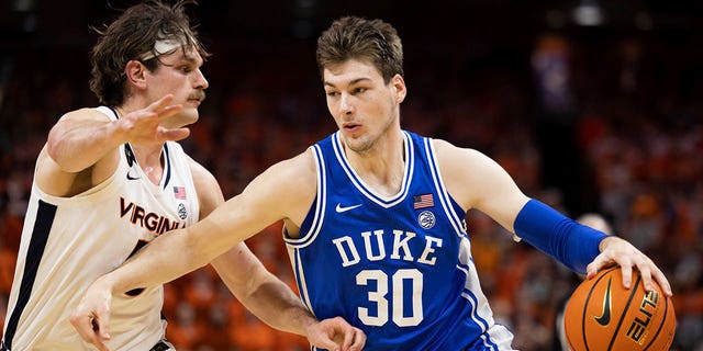 Duke's Kyle Filipowski (30) drives against Virginia's Ben Vander Plas (5) during the first half of a game in Charlottesville, Va., Saturday, Feb. 11, 2023. 