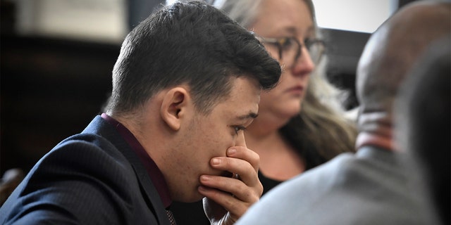 Kyle Rittenhouse puts his hand over his face after he is found not guilt on all counts at the Kenosha County Courthouse in Kenosha, Wis., on Friday, Nov. 19, 2021. 