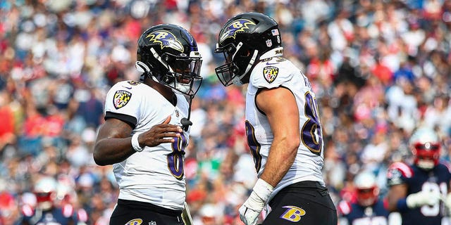 Quarterback Lamar Jackson, #8 of the Baltimore Ravens, celebrates with tight end Mark Andrews, #89 of the Baltimore Ravens, after Andrews' touchdown during the second quarter against the New England Patriots at Gillette Stadium on September 25, 2022, in Foxborough, Massachusetts.