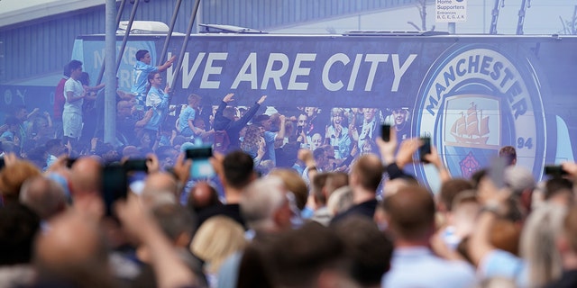 Fans welcome Manchester City players before the start of the match against Aston Villa in Manchester, England, Sunday, May 22, 2022.