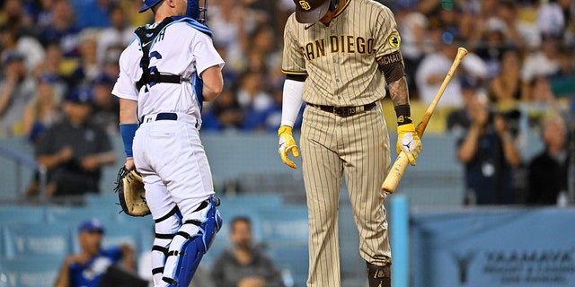 San Diego Padres third baseman Manny Machado hangs his head after being called out on strikes in the sixth inning of a game against the Los Angeles Dodgers at Dodger Stadium in Los Angeles on Aug. 5, 2022.