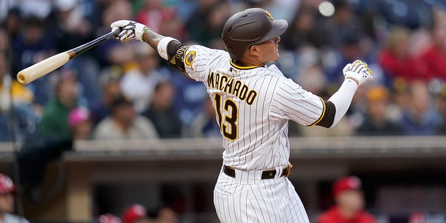 The San Diego Padres' Manny Machado hits a two-run home run during the first inning of a game against the Cincinnati Reds at Petco Park in San Diego on April 19, 2022.