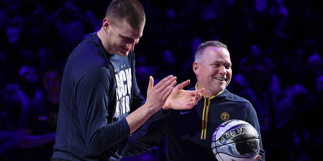 Nikola Jokic, #15, and Michael Malone, of the Denver Nuggets, are recognized for making the NBA All-Star Game during the game against the Dallas Mavericks at Ball Arena on Feb. 15, 2023 in Denver.