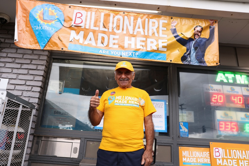 Owner Joseph Chahayed poses after a single winning ticket for the Powerball lottery drawing was sold in at Joe's Service Center, in Altadena, California, U.S., November 8, 2022. 