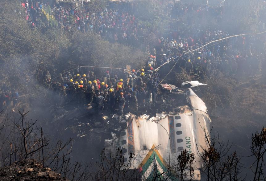 A general view of rescue teams working near the wreckage at the crash site of a Yeti Airlines ATR72 aircraft in Pokhara, central Nepal.