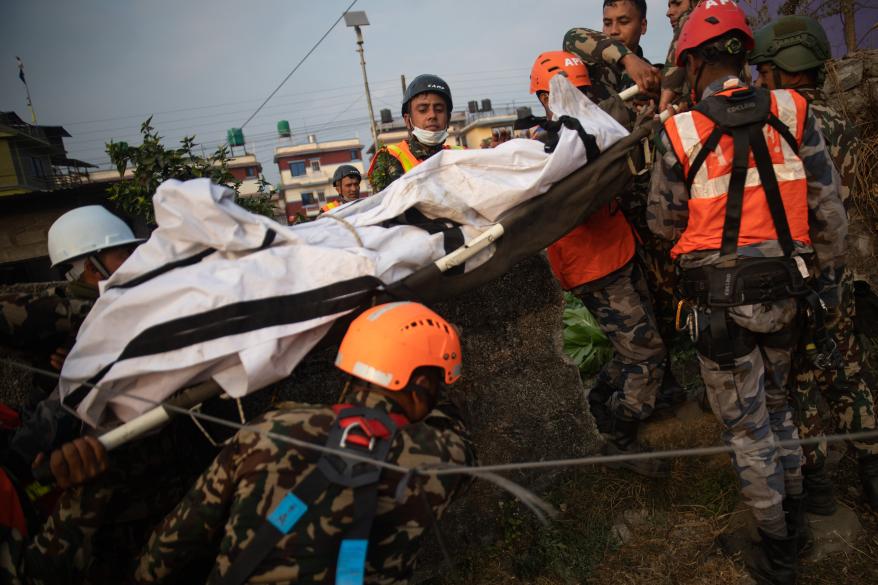 Nepal army, Police, AFP Rescuers recover the body of a victim who died in a Yeti Airlines plane crash in Pokhara.
