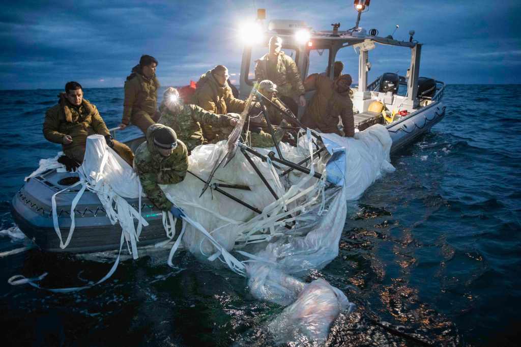 Sailors assigned to Explosive Ordnance Disposal Group 2 recover a high-altitude surveillance balloon off the coast of Myrtle Beach, South Carolina, in the Atlantic Ocean on Feb. 5, 2023.