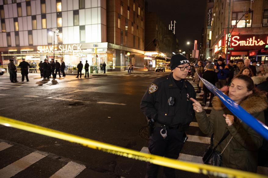 Police officers are seen at shooting scene on 44th St. and 8th Ave.