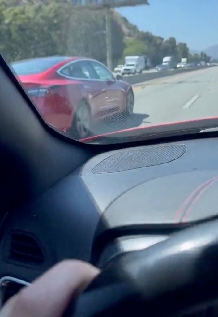 The red Tesla sedan operated by the drowsy driver was traveling in the "fast lane."