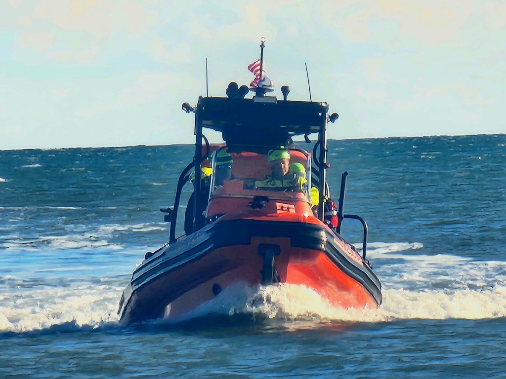 An orange power boat driving in what appears to be the ocean off South Carolina.