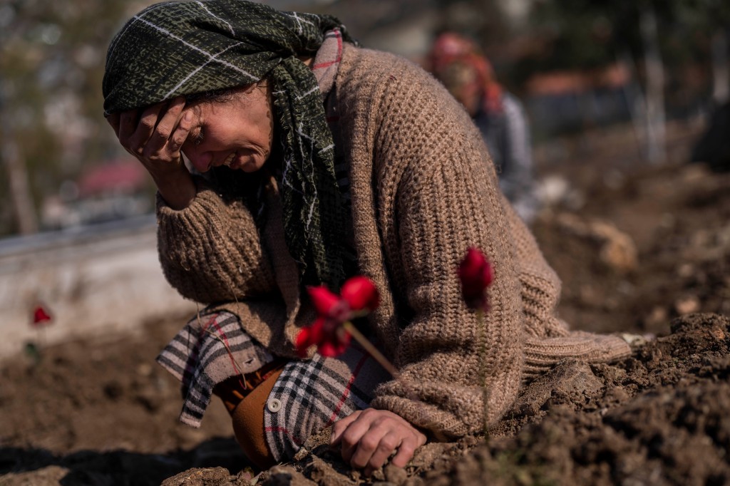 A member of the Vehibe family mourns a relative during a burial in the border region of Turkey and Syria.