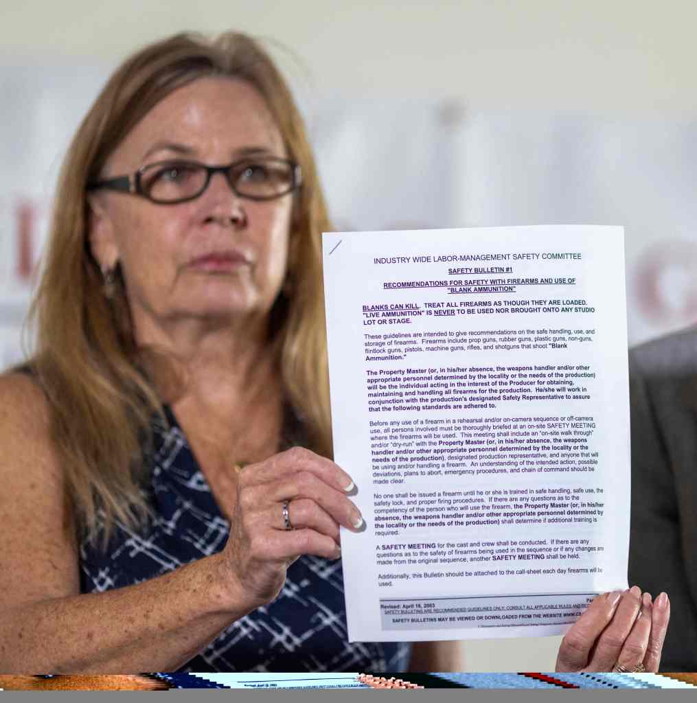 Mitchell holding a copy of safety recommendations