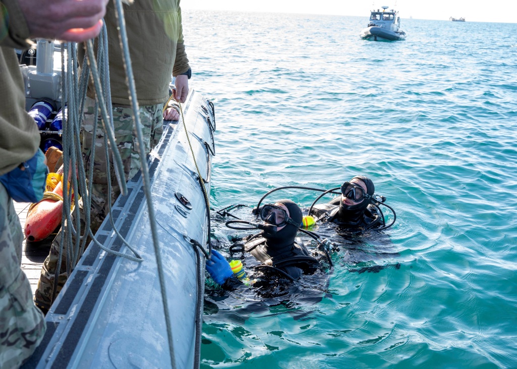 Sailors assigned to Assault Craft Unit 4 prepare material recovered in the Atlantic Ocean.