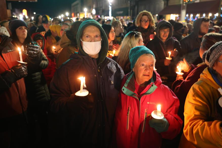 People attend a vigil downtown to honor those killed and wounded during the shooting at Oxford High School.