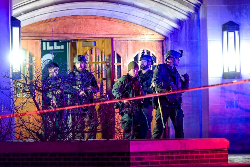 Police walk around Berkey Hall on Michigan State Campus after a mass shooting Monday night.