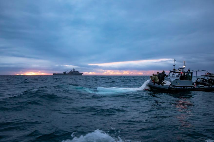 Sailors conduct pre-dive checks during recovery efforts for debris from a Chinese high-altitude balloon in the Atlantic Ocean.