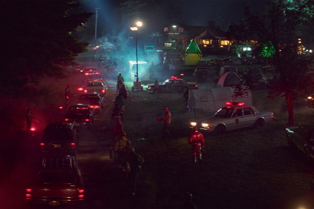 White Noise movie still of cars evacuating in the night after explosion