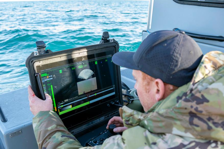 A sailor conducts a search for debris with an underwater vehicle during recovery efforts of a Chinese high-altitude balloon in the Atlantic Ocean.