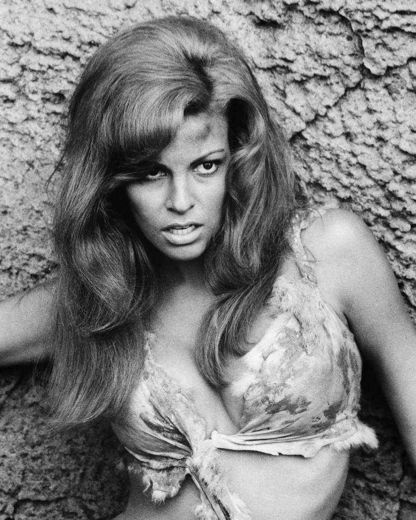 Raquel Welch wearing an animal hide bikini, posing against a rock, in a publicity portrait issued for the film, 'One Million Years BC" in 1966.