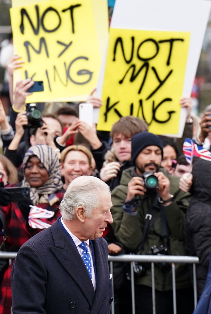 Demonstrators hold placards reading "Not My King" as Britain's King Charles III