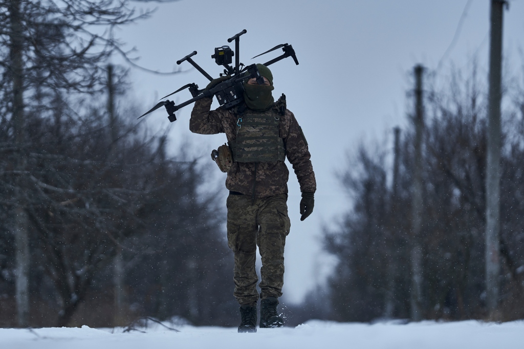 A Ukrainian soldier carries a drone close to the frontline near Avdiivka, Donetsk region, Ukraine, Friday, Feb. 17.