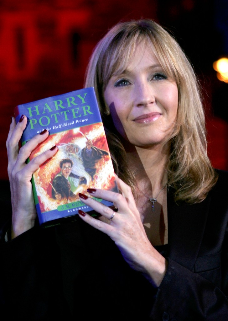 J.K. Rowling holding "Harry Potter and the Half-Blood Prince," which was released in 2005.