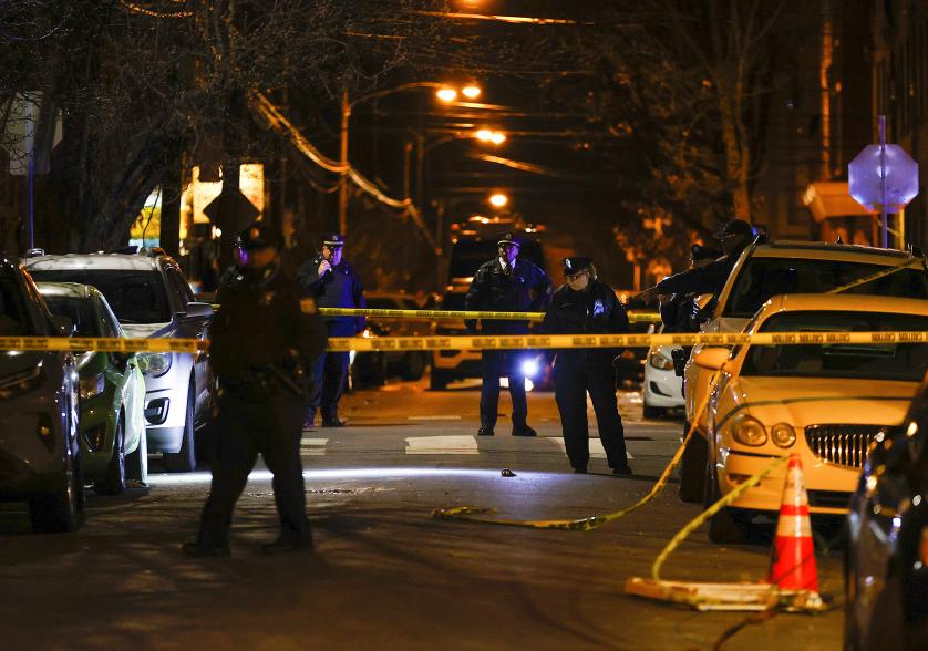 Philadelphia police officers investigate the fatal shooting of a Temple University police officer near the campus on Saturday.