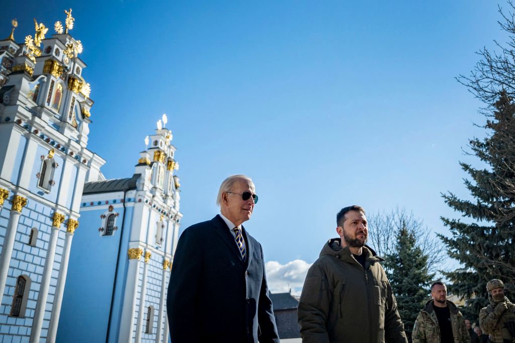 US President Joe Biden (L) walking next to Ukrainian President Volodymyr Zelensky (R) in front of St. Michaels Golden-Domed Cathedral as he arrives for a visit in Kyiv.