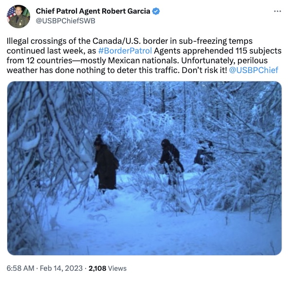 Group walking through snow to cross into the US from Canada.