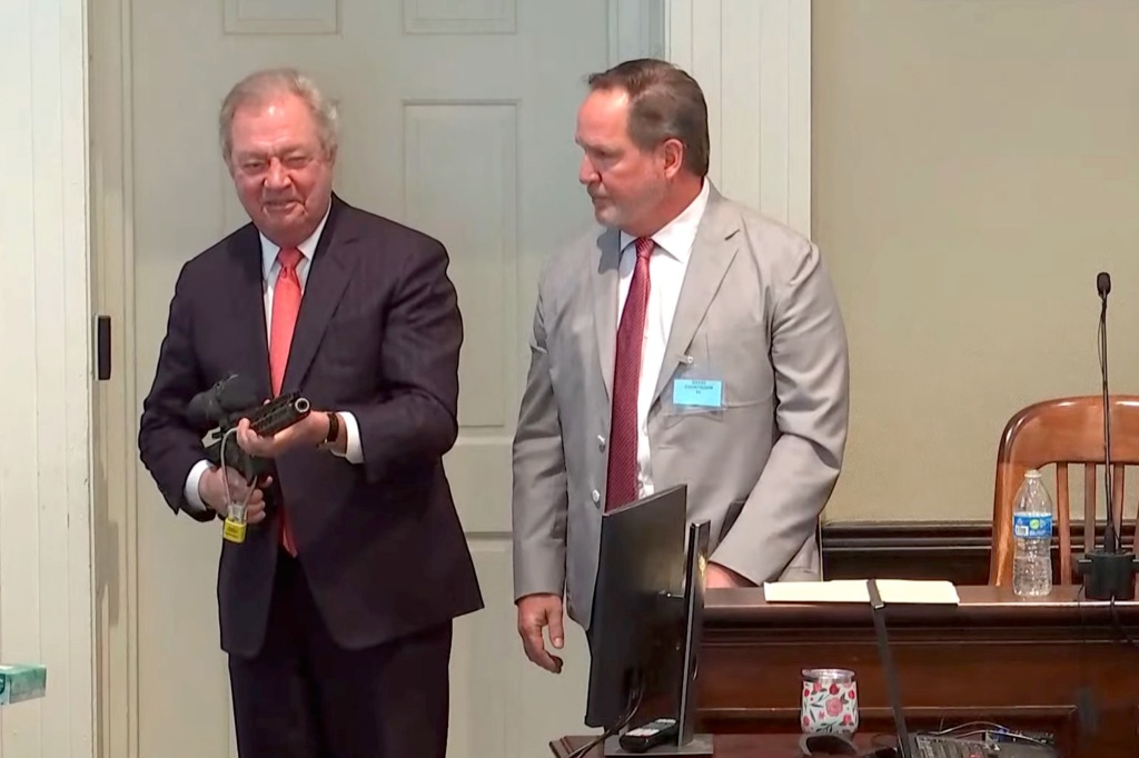 Dick Harpootlian points gun at prosecution table