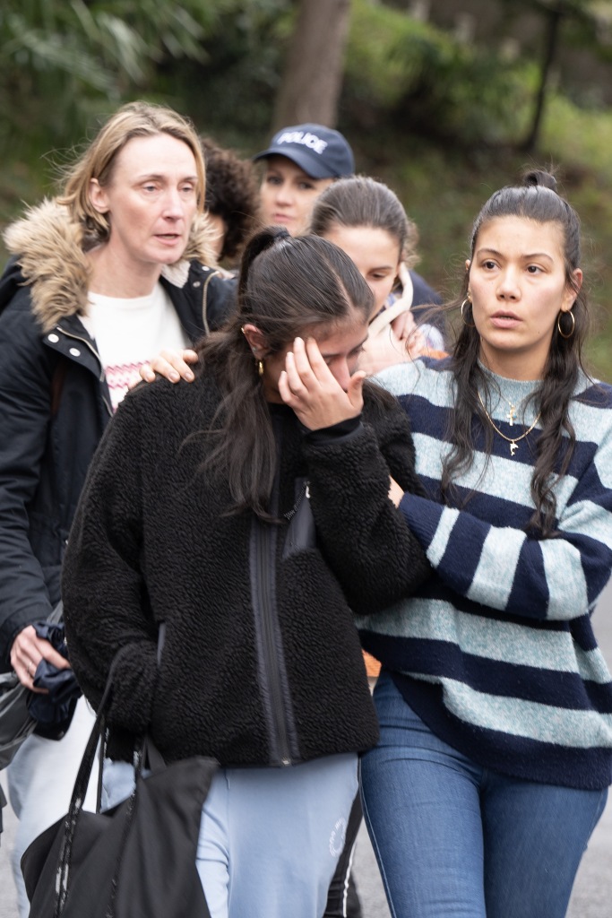 A student is comforted as she leaves St Thomas d'Aquin high school in St-Jean-de-Luz, in southwestern France, 22 February 2023.