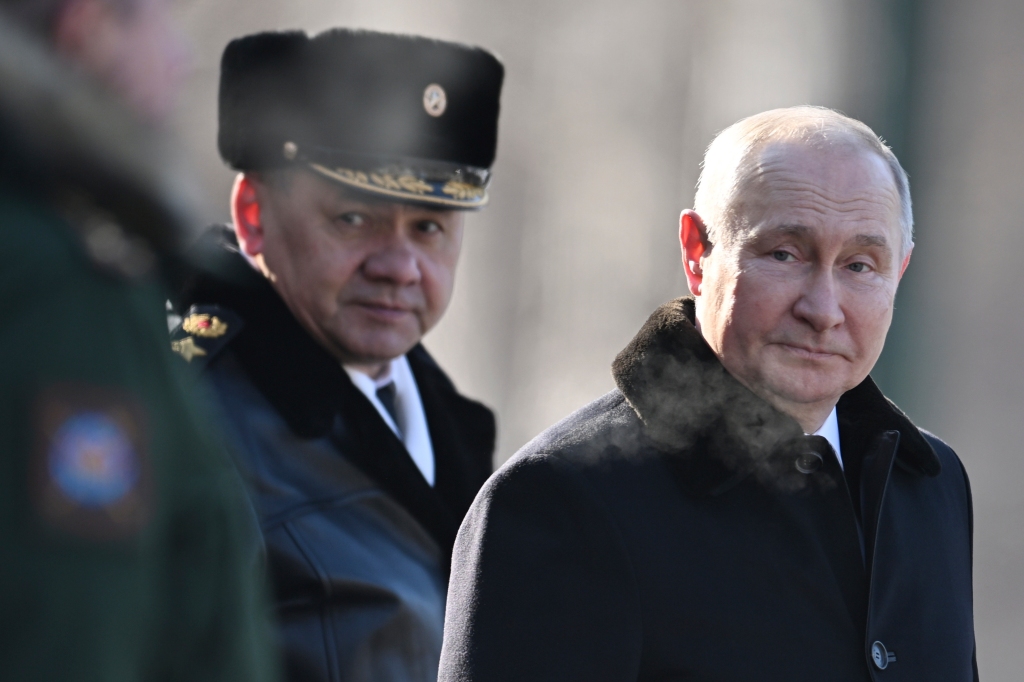 Russian President Vladimir Putin, right, and Russian Defence Minister Sergei Shoigu attend a wreath-laying ceremony at the Unknown Soldier's Grave in the Alexander Garden during the national celebrations of the "Defender of the Fatherland Day" in Moscow, Russia, Thursday, Feb. 23.