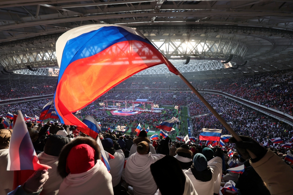 
Participants wave Russian national flags during the ''Glory to the Defenders of the Fatherland'' concert waiting for Russian President Vladimir Putin, a day before the Defender of the Fatherland Day, a holiday honoring Russia's armed forces at the Luzhniki Stadium in Moscow, Russia, 
