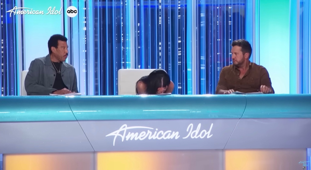 While Luke Bryan praised Louise, Perry was overcome with emotion and slumped forward on the table