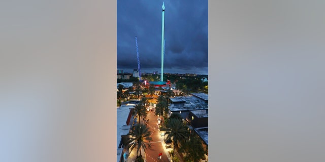 Tourists enjoy the rides and amenities at ICON Park in Orlando on Thursday, March 24, 2022. The Orlando FreeFall ride is pictured in the middle, towering over the restaurant area of the park. It will be dismantled after the owner reached a settlement with the Florida Department of Agriculture and Consumer Services.