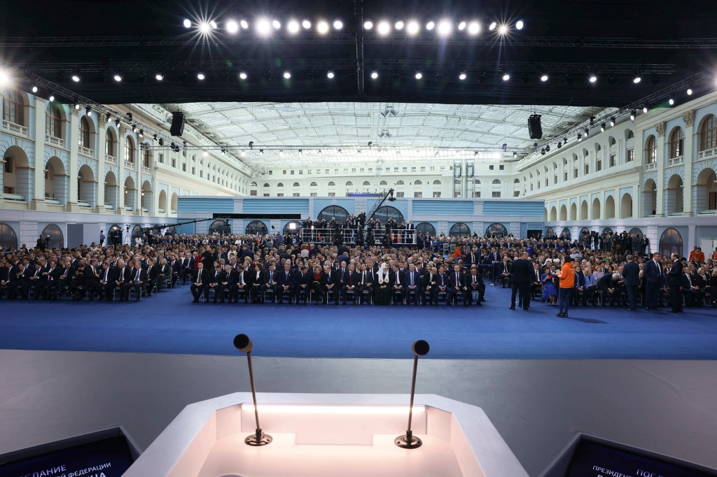 Participants gather to listen Russian President Vladimir Putin's annual state of the nation address in Moscow, Russia, Tuesday, Feb. 21, 2023.