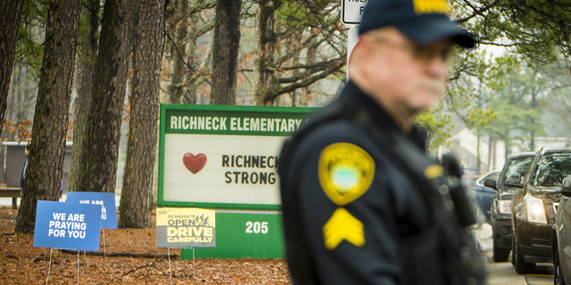 A Newport News police officer directs traffic at Richneck Elementary School in Newport News, Virginia, on Monday Jan. 30.