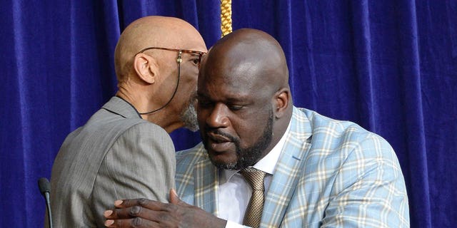 Kareem Abdul-Jabbar, left, and Shaquille O'Neal hug as the Los Angeles Lakers unveil the Shaquille O'Neal statue on March 24, 2017, at Staples Center (now Crypto.com Arena) in Los Angeles.