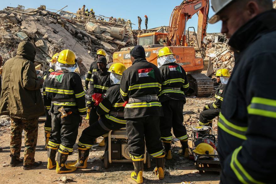 Turkish rescuers standing by a collapsed building in Adiyaman, southern Turkey, Saturday, Feb. 11, 2023.