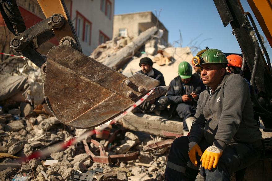 Turkish rescue workers stand by a collapsed building in Adiyaman, southern Turkey, Saturday, Feb. 11, 2023.