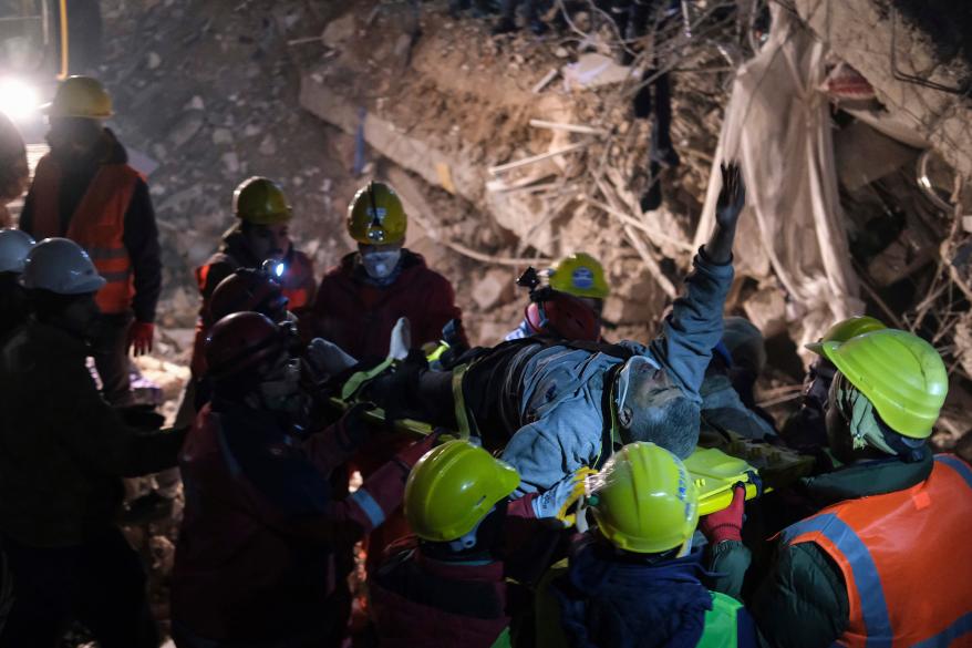 Rescuers carry Abdulkerim Nano, 67, to an ambulance after they pulled him out five days after the Monday earthquake in Kahramanmaras, southern Turkey, late Saturday, Feb. 11, 2023.