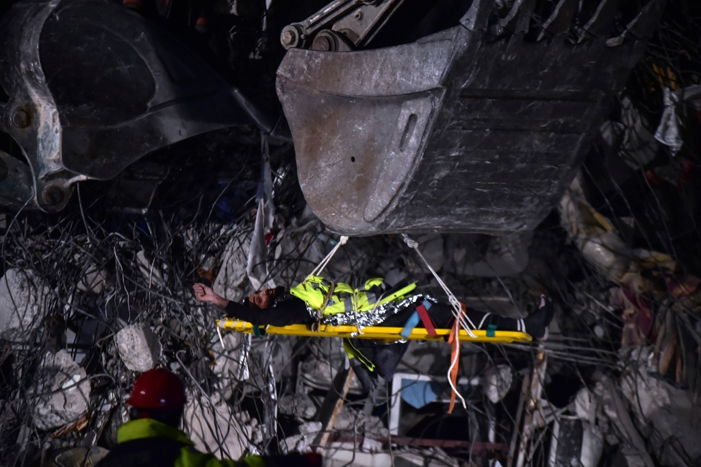 Rescuers use a crane to pull out Muhammet Habib, 27, from a collapsed building in Kahramanmaras, southern Turkey, late Saturday, Feb. 11, 2023.